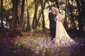 bride and groom laughing in bluebell forest