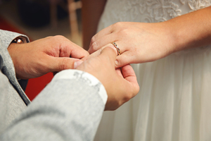 close up of brides hand as she's receiving her wedding ring