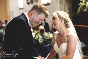 bride and groom laughing in church