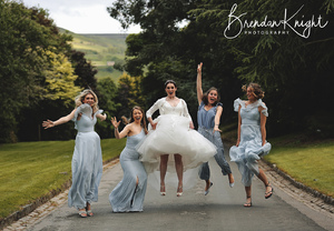 bride and bridesmaids jumping